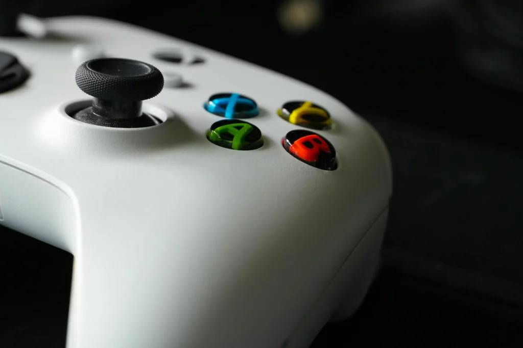A close-up of a white Xbox controller with colorful buttons, representing gaming identity by Quick Counter Tools.