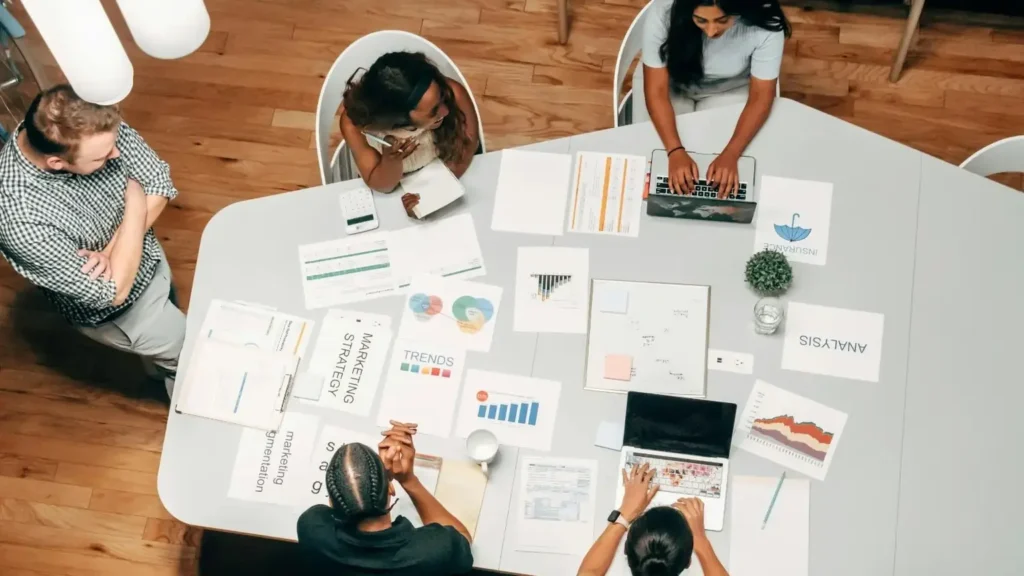 The team is using a combined words generator to brainstorm a creative business name during a strategic marketing meeting.